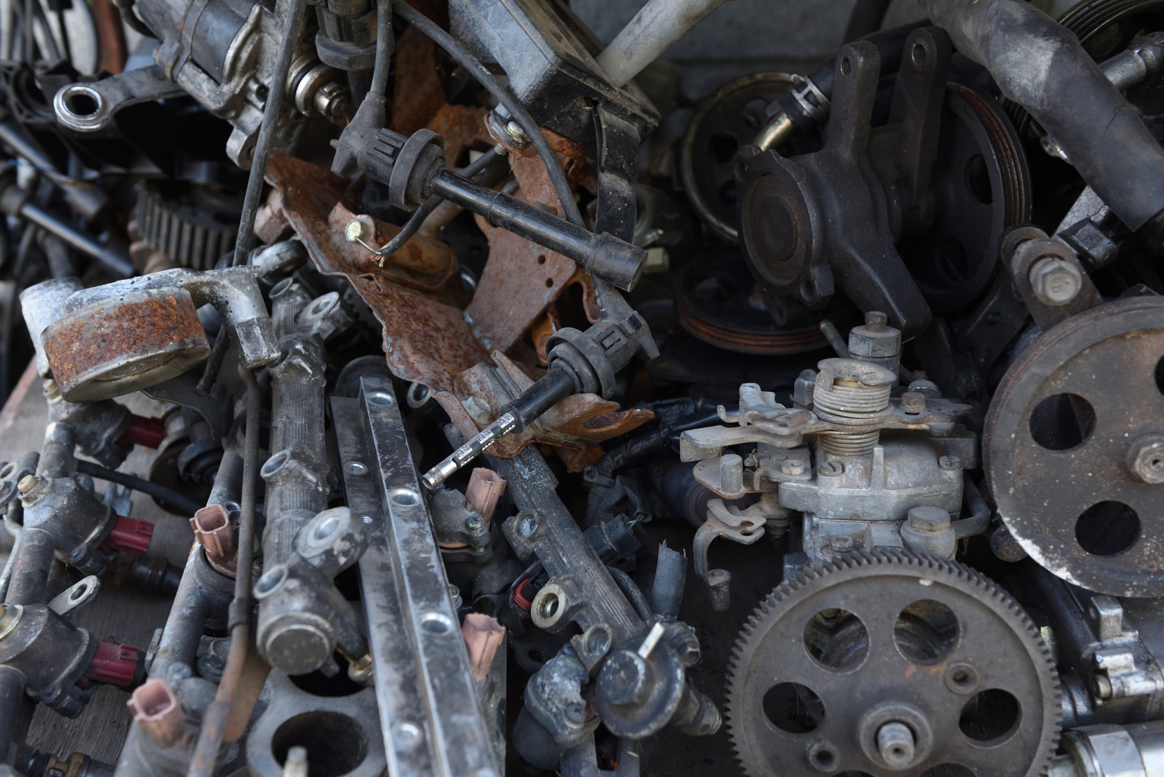 Scrap metal car parts on the floor and if you need to rid your company's scrap metal find a great company in Burnham who can take it.